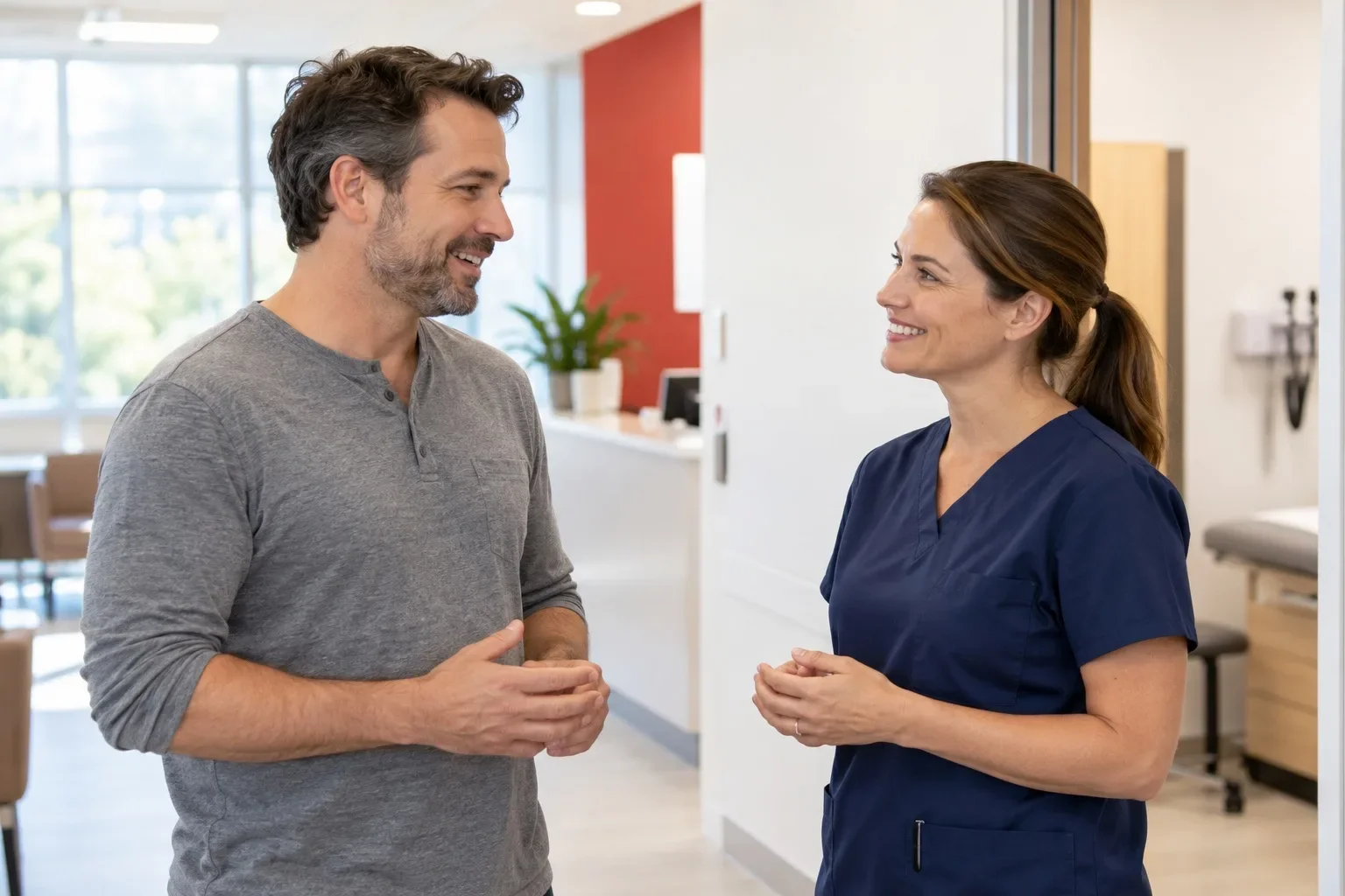 Illustrative adult and clinician speaking in a bright clinic